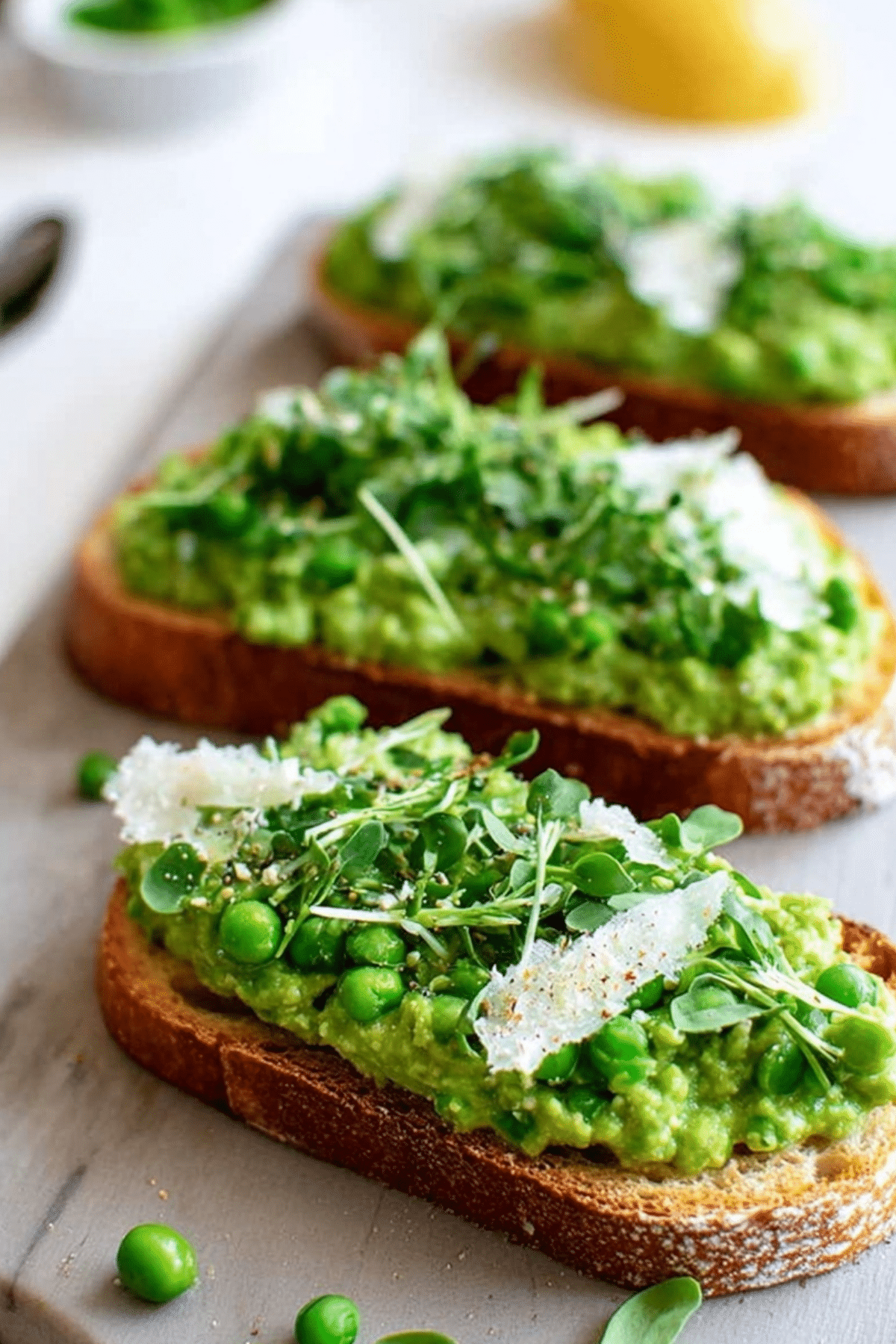 Pea Bruschetta with pea pesto, parmesan, and lemon zest on ciabatta