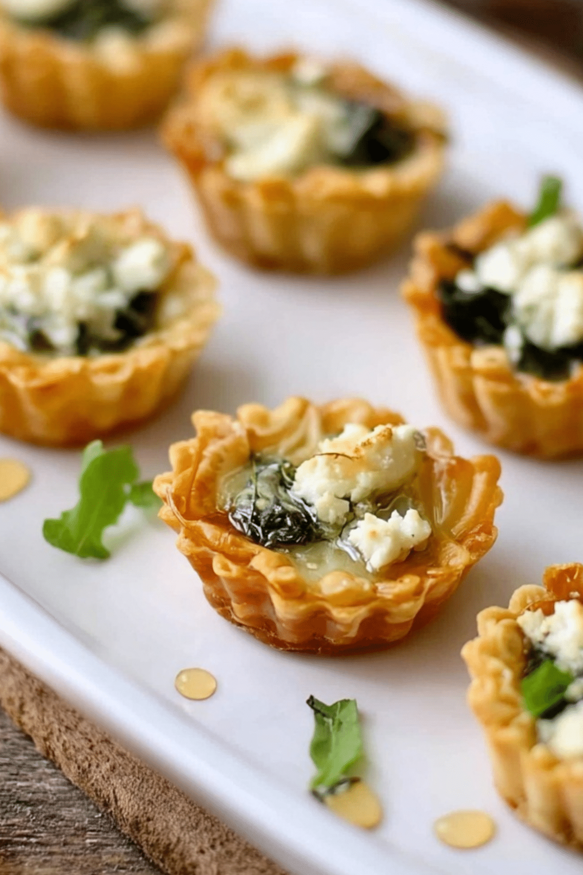 Spring Herb Tartlets with Honey and Goat Cheese served on a platter