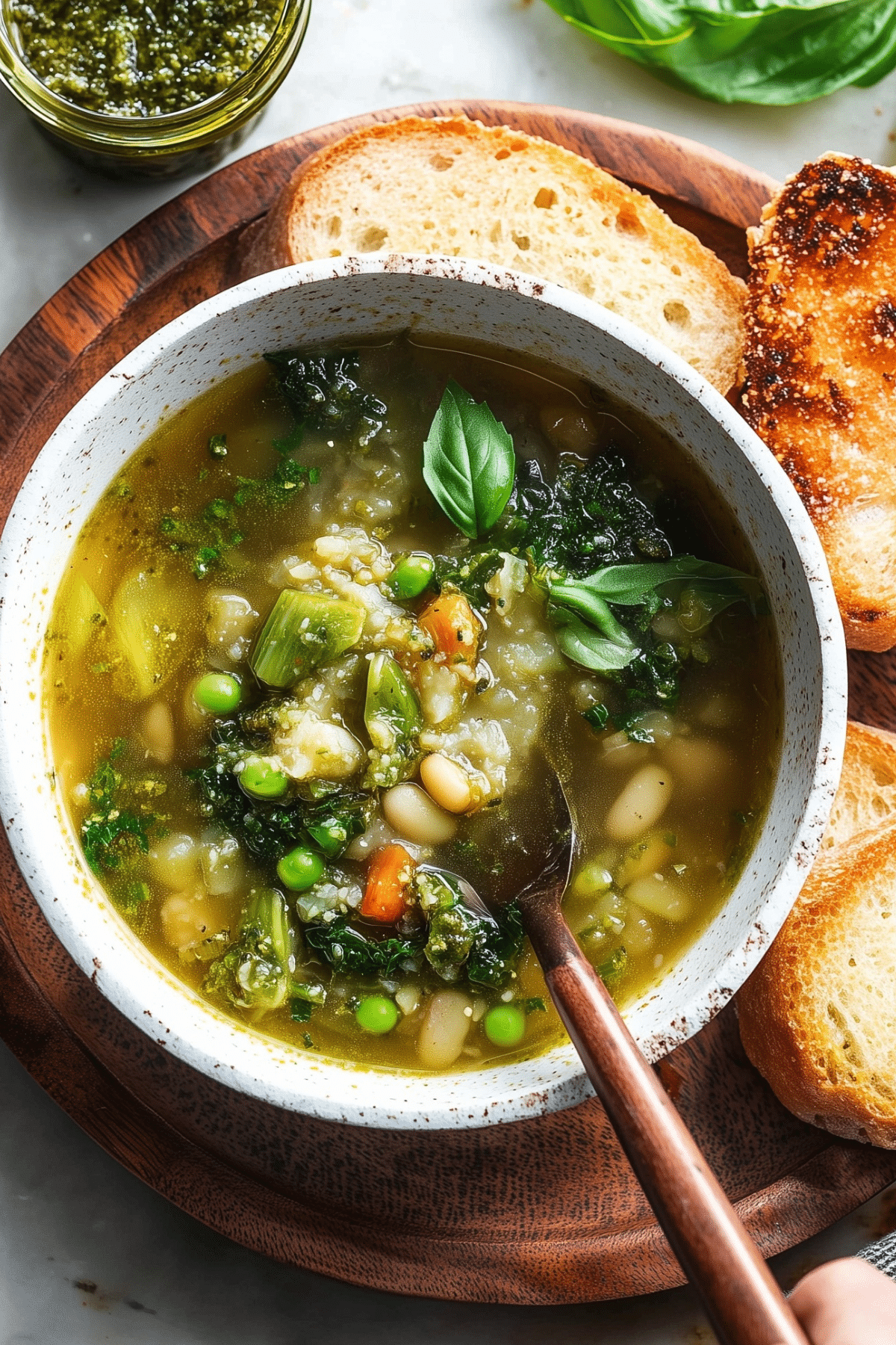 Spring Pistou Soup in a bowl with basil pistou on top