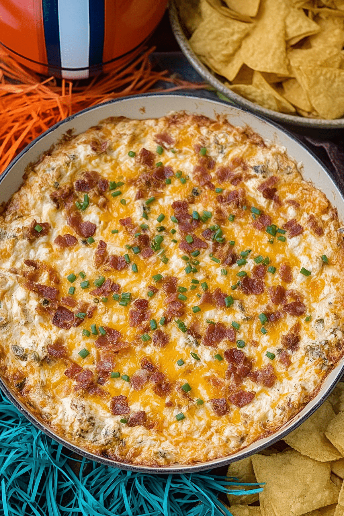 Warm Crack Chicken Dip baked with cheddar cheese and crispy bacon on top