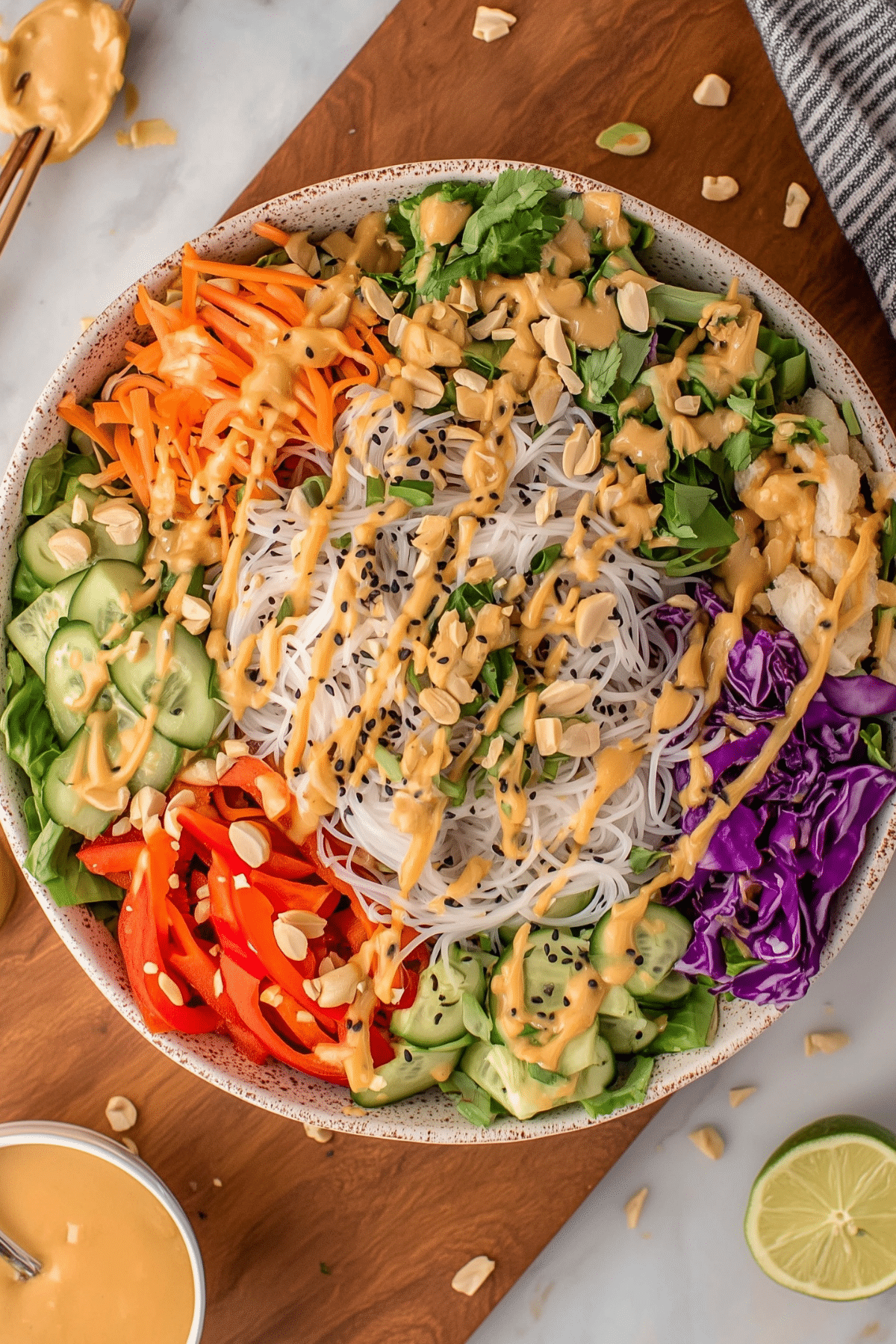 Fresh spring roll salad with vermicelli noodles, vegetables, herbs, and peanut dressing