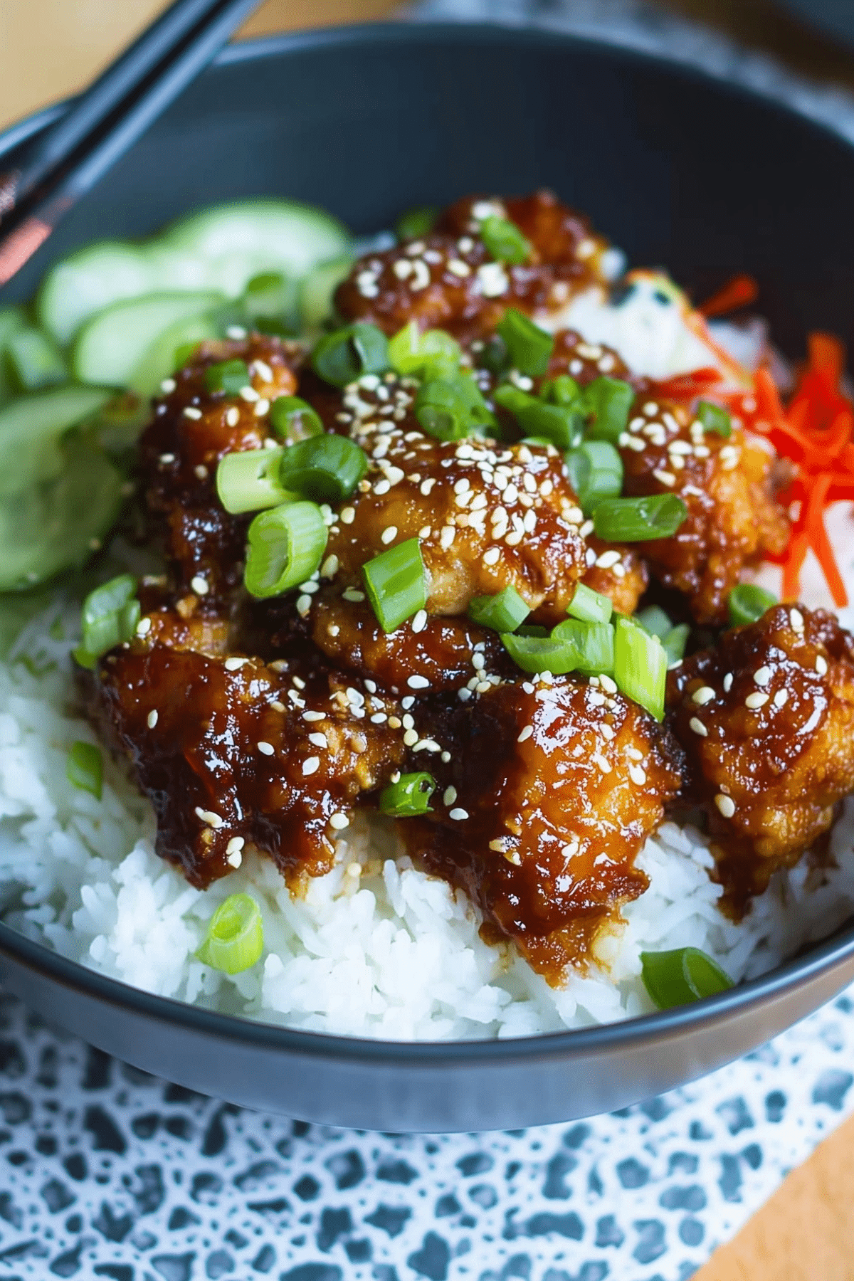 Sticky Chicken Rice Bowl with crispy chicken, sesame seeds, and rice